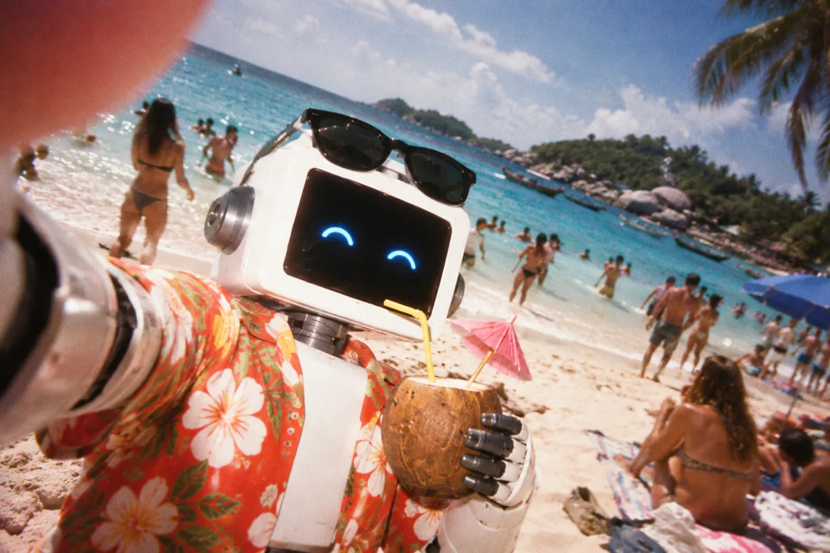 the agent takes a crooked selfie on a crowded beach with his thumb over the lens, coconut in hand